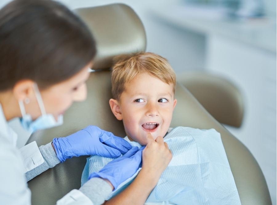 orthodontist checking a kid's teeth