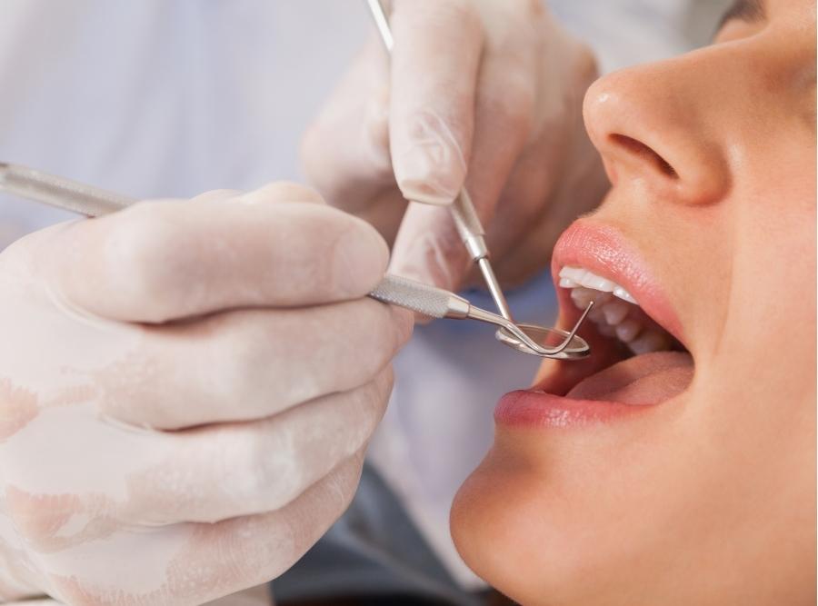 orthodontist checking patient's teeth